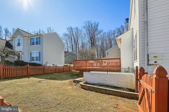 view of yard with a fenced backyard and a deck