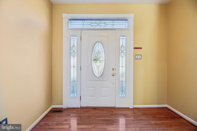 entrance foyer with visible vents, baseboards, and wood finished floors