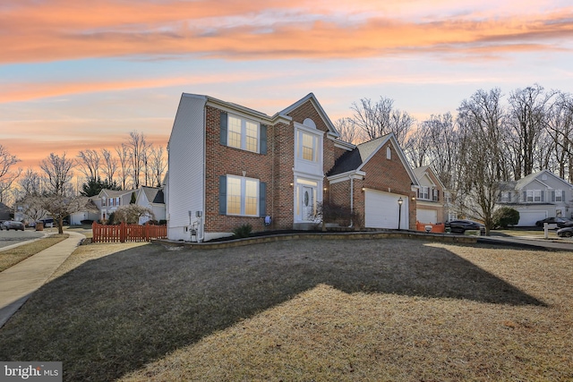 view of front facade featuring a residential view, brick siding, and a yard