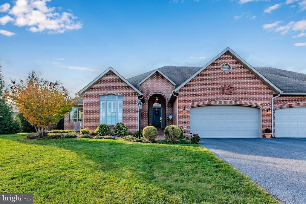 view of front of house with a front yard and a garage