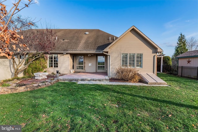 back of house featuring a patio and a lawn