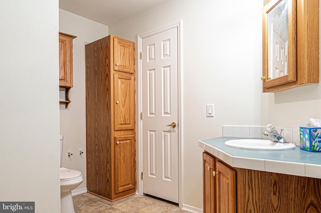 bathroom featuring tile patterned floors, toilet, and vanity