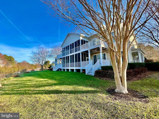 view of side of home with a yard