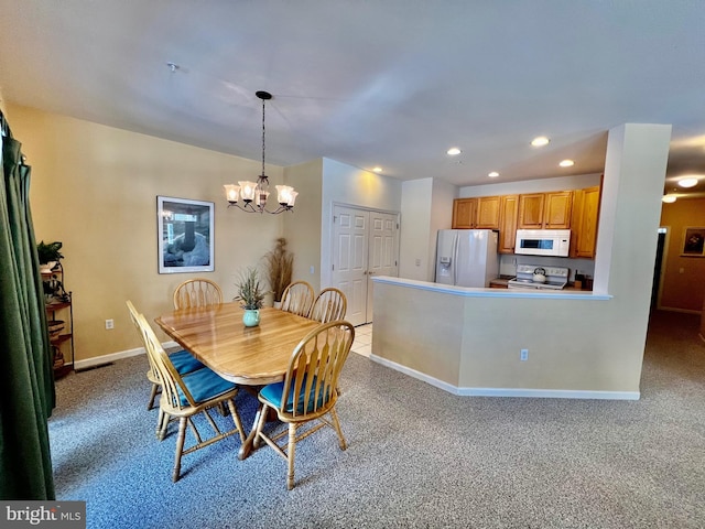 dining room featuring light carpet and a notable chandelier