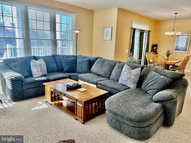 living room featuring carpet and a chandelier