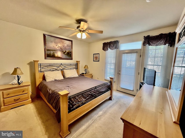 carpeted bedroom featuring access to exterior and ceiling fan