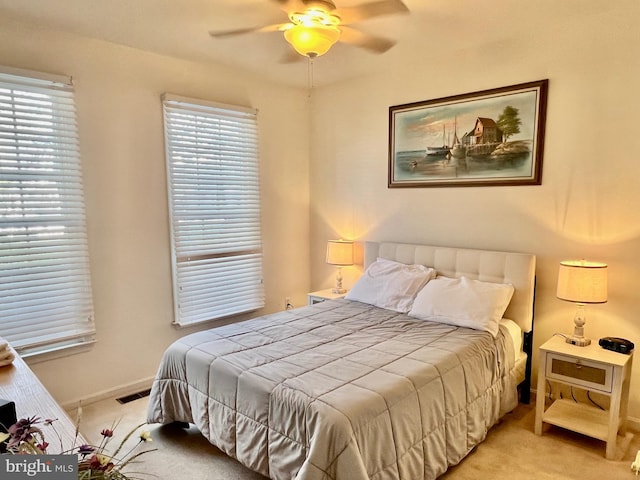 bedroom featuring light colored carpet and ceiling fan