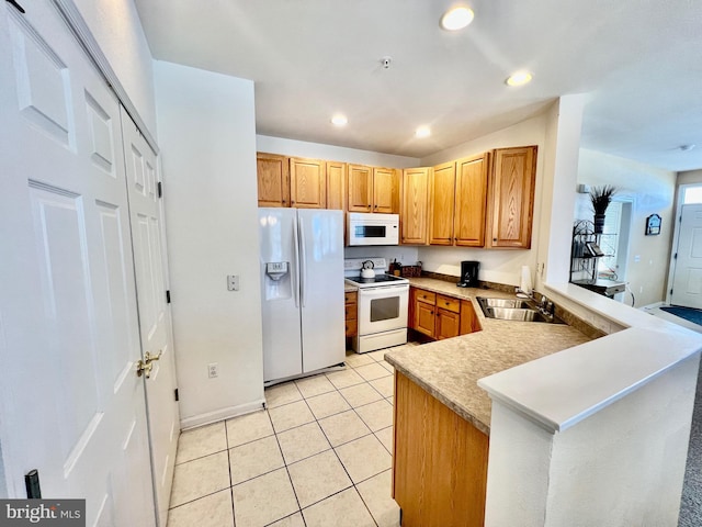 kitchen featuring kitchen peninsula, sink, light tile patterned flooring, and white appliances