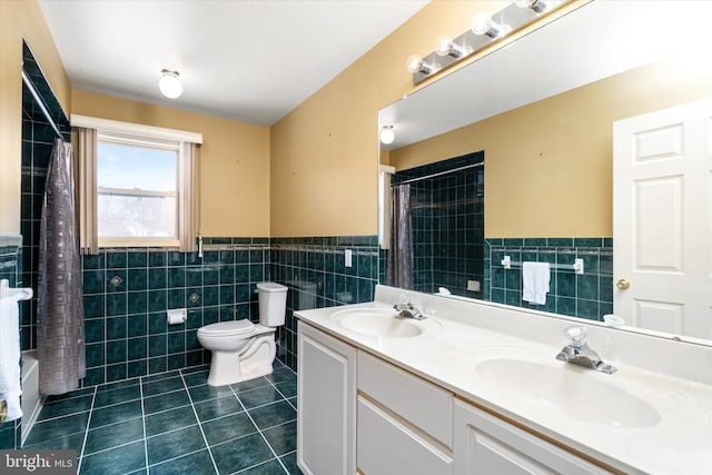 full bathroom with toilet, tile walls, tile patterned flooring, shower / bath combination with curtain, and vanity