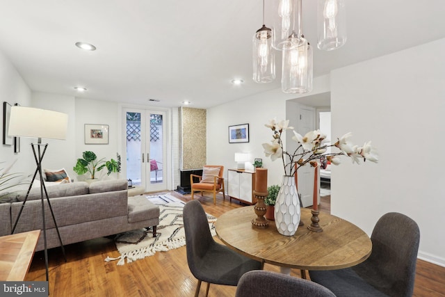 dining space with hardwood / wood-style floors and french doors