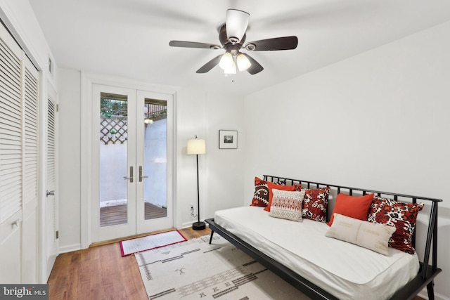 bedroom featuring french doors, ceiling fan, a closet, and light hardwood / wood-style flooring