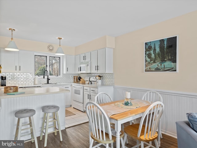 dining room featuring sink and light wood-type flooring