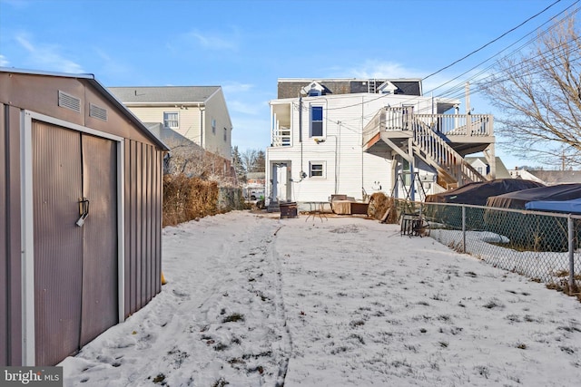 snow covered property with a wooden deck