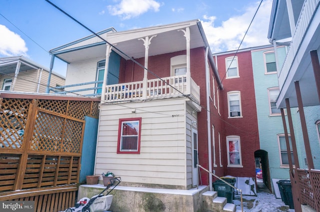 rear view of property featuring a balcony