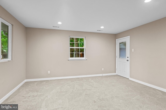 empty room featuring light colored carpet