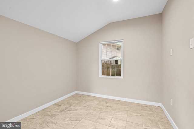 spare room featuring vaulted ceiling