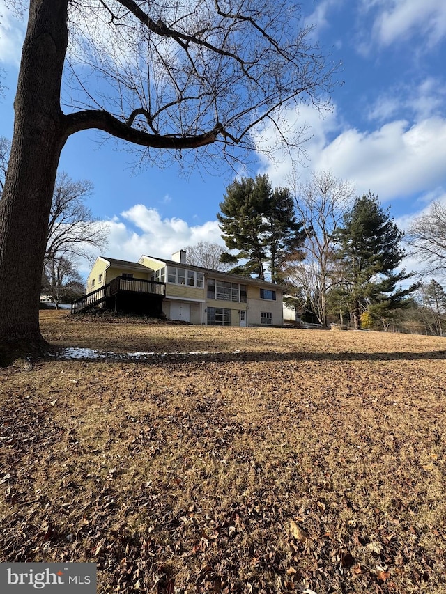 back of house with a deck