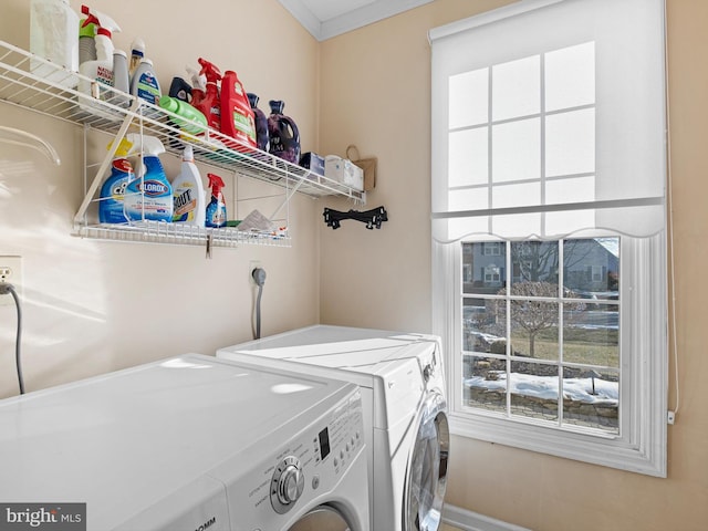 laundry room featuring washer and dryer and ornamental molding