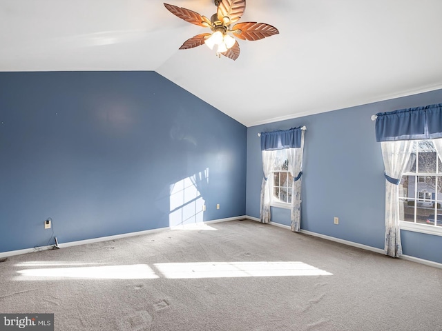 unfurnished room with ceiling fan, lofted ceiling, and carpet