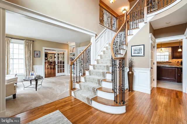 stairs with wood-type flooring and a wealth of natural light