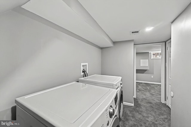 laundry room featuring washing machine and dryer, visible vents, dark colored carpet, and baseboards