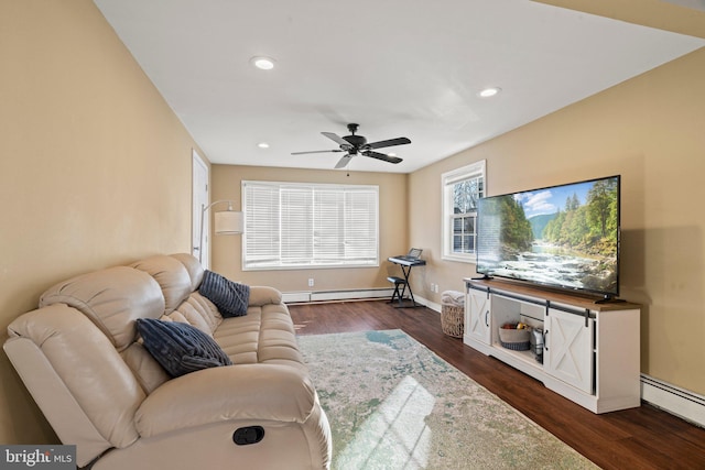 living room with ceiling fan, dark hardwood / wood-style flooring, and a baseboard heating unit