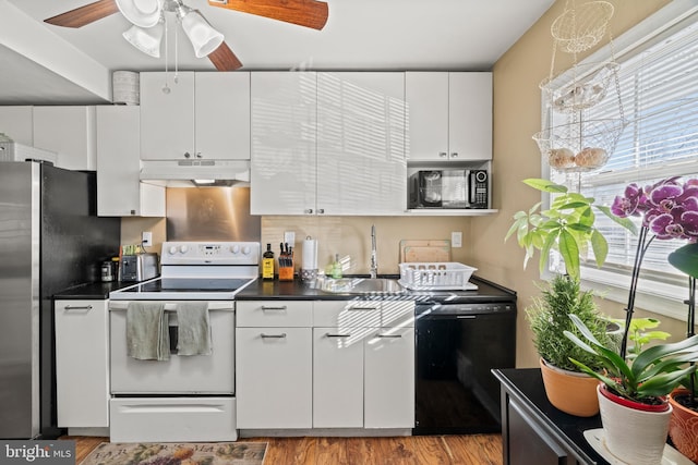 kitchen featuring black appliances, white cabinets, sink, ceiling fan, and light hardwood / wood-style floors