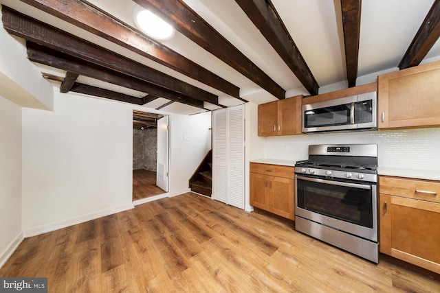 kitchen with backsplash, appliances with stainless steel finishes, beam ceiling, and light wood-type flooring