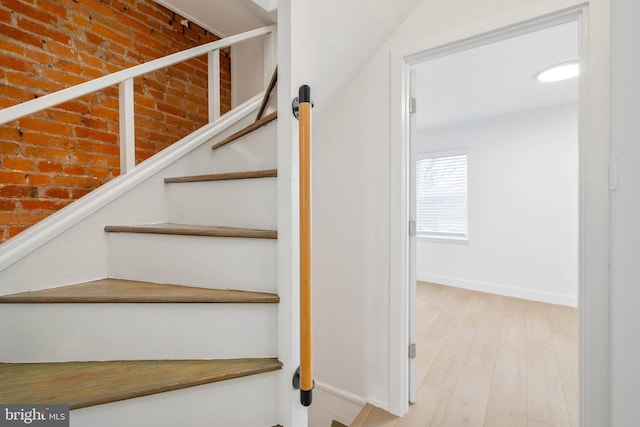 stairs featuring hardwood / wood-style flooring