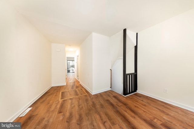 hall with wood-type flooring