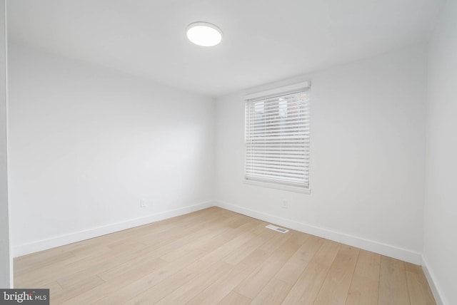 unfurnished room with light hardwood / wood-style flooring