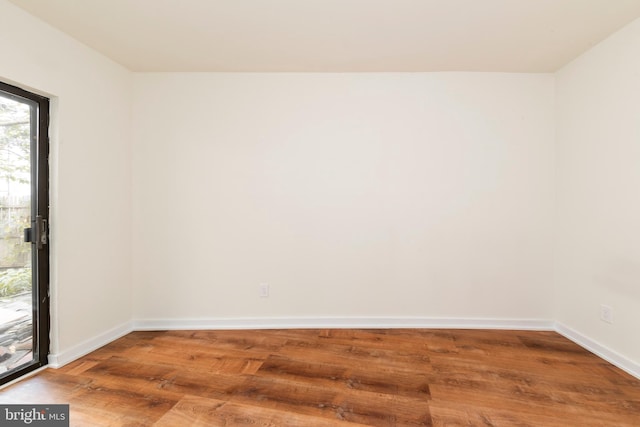 spare room with hardwood / wood-style flooring