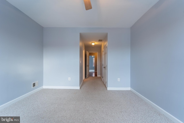 spare room with ceiling fan and light colored carpet