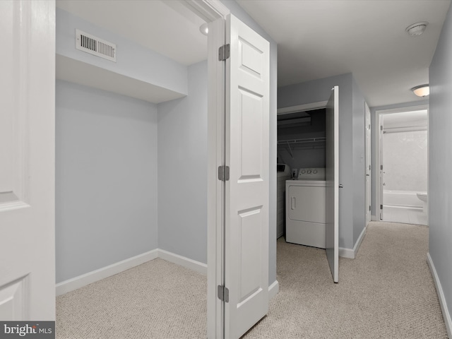 159 N Ellwood Ave, Baltimore, MD 21224 - hallway with carpet flooring, baseboards, visible vents, and washing machine and clothes dryer