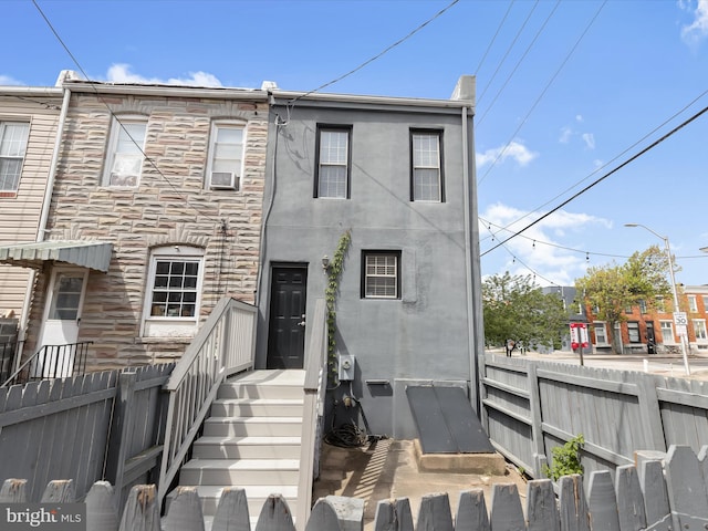159 N Ellwood Ave, Baltimore, MD 21224 - view of front facade with fence and stone siding