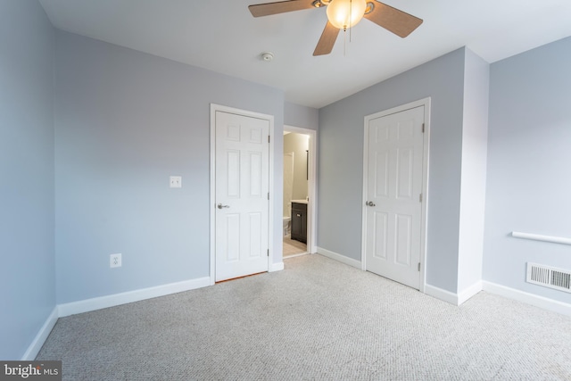 unfurnished bedroom with ceiling fan and light colored carpet