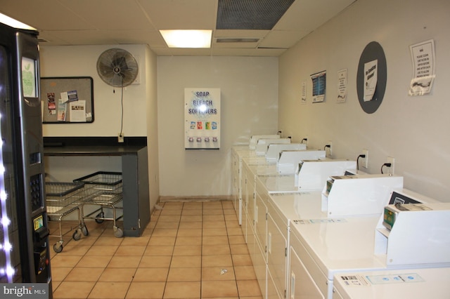 laundry area with washer and dryer and light tile patterned floors