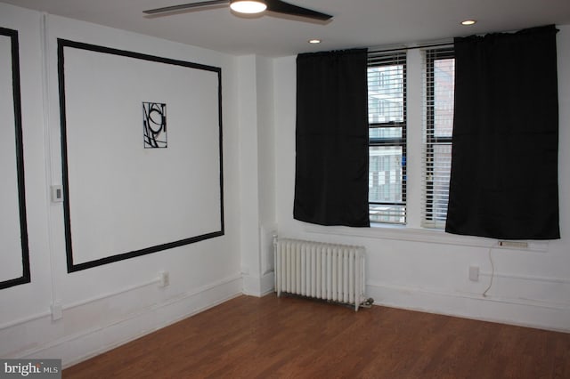 unfurnished room with radiator, ceiling fan, and hardwood / wood-style flooring