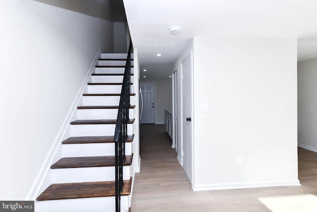 stairway featuring hardwood / wood-style floors