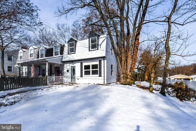 new england style home featuring covered porch