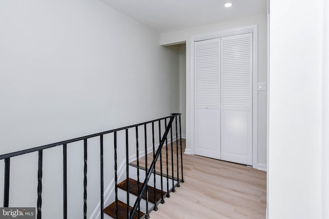 stairs featuring hardwood / wood-style floors