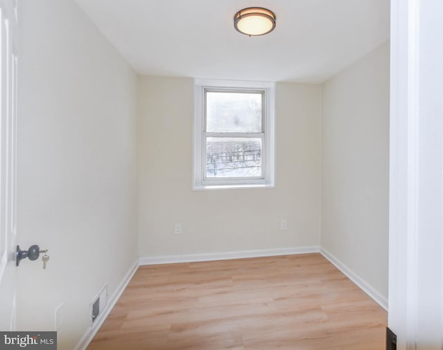 unfurnished room with light hardwood / wood-style flooring