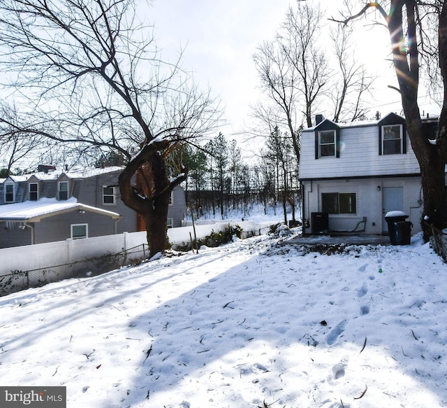 snowy yard featuring central air condition unit