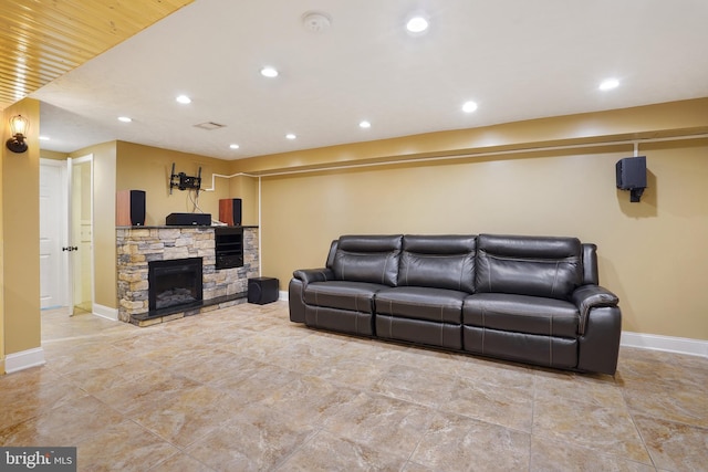 living room with a stone fireplace