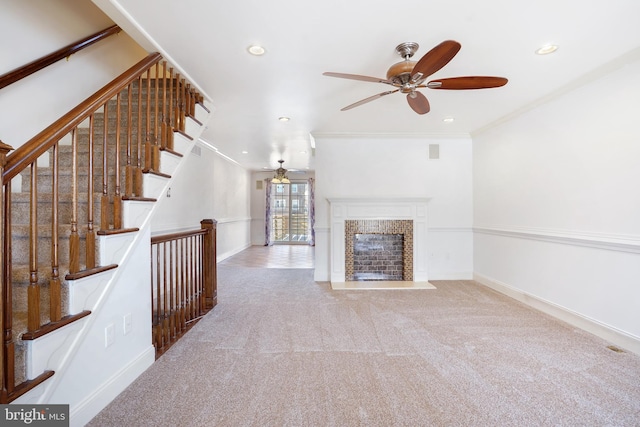 unfurnished living room featuring light carpet, ceiling fan, and crown molding