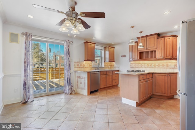 kitchen featuring backsplash, a healthy amount of sunlight, ceiling fan, and stainless steel appliances