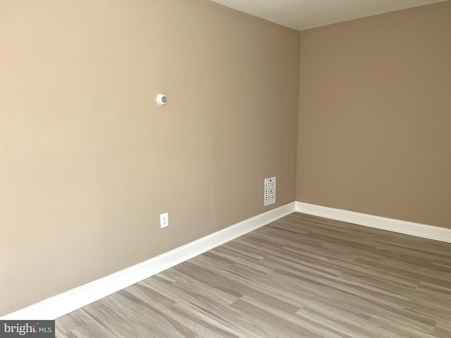 unfurnished room with light hardwood / wood-style flooring