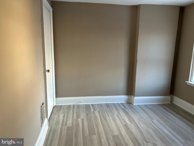 spare room featuring light wood-type flooring