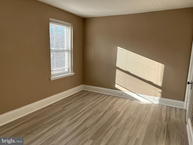 spare room featuring wood-type flooring