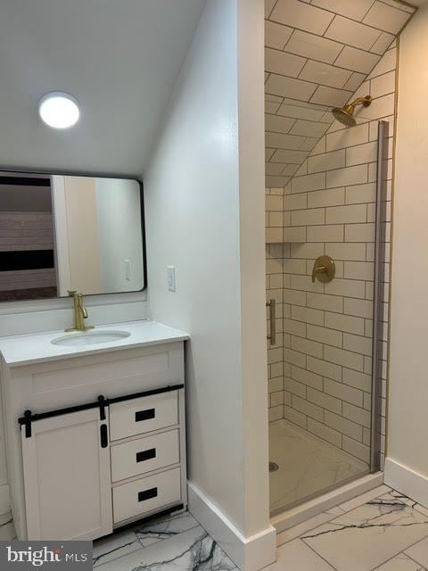 bathroom with marble finish floor, baseboards, a stall shower, and vanity